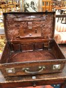 A VINTAGE LEATHER SUITCASE WITH INTERIOR POCKETS. W 65cms.