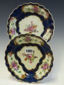 A PAIR OF FIRST PERIOD WORCESTER BLUE SCALE PLATES, EACH PAINTED WITH GOLD FRAMED RESERVES OF