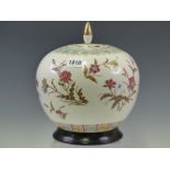 A CHINESE JAR, COVER AND WOOD STAND PAINTED WITH SPRAYS OF FLOWERS WITHIN LAPPET BANDS ON THE