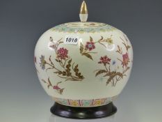 A CHINESE JAR, COVER AND WOOD STAND PAINTED WITH SPRAYS OF FLOWERS WITHIN LAPPET BANDS ON THE