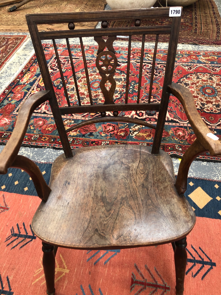 A 19th C. LINE INLAID ELBOW CHAIR THE WHEEL SPLAT FLANKED BY THREE BARS ABOVE AN OAK SADDLE SEAT
