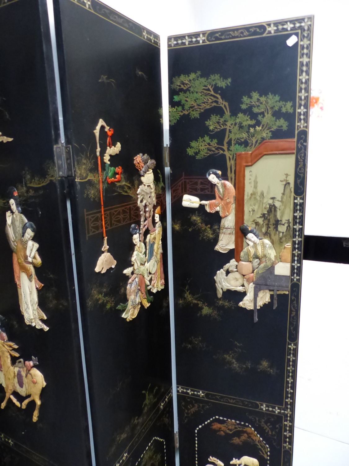 A CHINESE LACQUER AND INLAID SIX FOLD FLOOR SCREEN, DECORATED WITH FIGURES IN RELIEF IN TERRACES AND - Image 4 of 21