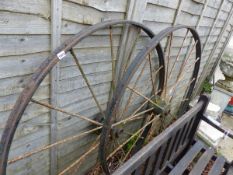 A PAIR OF LARGE IRON WAGON WHEELS.