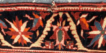 AN ANTIQUE PERSIAN SAROUK RUG 217 x 125 cms