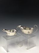 A SILVER TRIIFID FOOTED SAUCE BOAT BY WILLIAM NEALE, BIRMINGHAM 1925 WITH A GADROONED RIM TOGETHER