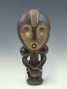 A LATE 19th C. ASANTE, MAHOGANY FERTILITY DOLL, HER FACE PAINTED IN OCHRE WITH WHITE DETAILS,