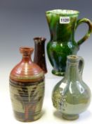 A STUDIO POTTERY BLUE GLAZED BELLARMINE, A GREEN GLAZED JUG. A BROWN STONE WARE VASE BY J H R AND