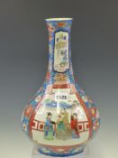 A JAPANESE IMARI OVERGLAZE BLUE GROUND BOTTLE VASE PAINTED WITH TWO FIGURE RESERVES. H 34cms.