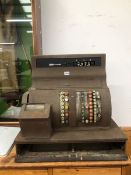 A HAND OPERATED METAL CASED CASH TILL WITHOUT ITS DRAWER FOR CASH