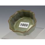A CHINESE HEXAFOIL DISH GLAZED IN YUEH STYLE IN CRACKLED LAVENDER GREEN. W 9cms.