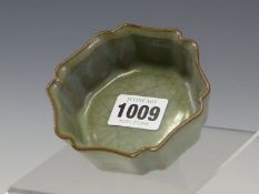 A CHINESE HEXAFOIL DISH GLAZED IN YUEH STYLE IN CRACKLED LAVENDER GREEN. W 9cms.