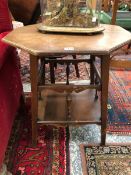 AN ARTS AND CRAFTS OCTAGONAL OAK TABLE ON FLARED SQUARE SECTIONED LEGS JOINED BY STRETCHERS WITH