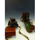 A ROLLEIFLEX TLR CAMERA, A POLAROID SX-70 LAND CAMERA IN ORIGINAL LEATHER POUCH, A KODAK VINTAGE