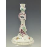 A DOT PERIOD MEISSEN PORCELAIN CANDLESTICK PAINTED WITH SPRIGS OF FLOWERS, THE ROCAILLE DETAILS OF