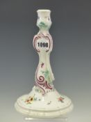 A DOT PERIOD MEISSEN PORCELAIN CANDLESTICK PAINTED WITH SPRIGS OF FLOWERS, THE ROCAILLE DETAILS OF