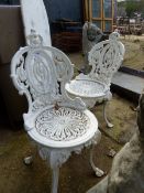 A PAIR OF PAINTED CAST IRON PATIO CHAIRS.