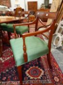 A SET OF TWELVE REGENCY STYLE MAHOGANY DINING CHAIRS, TO INCLUDE TWO WITH ARMS, EACH TOP RAIL