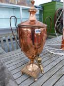 A TWO HANDLED COPPER HOT WATER URN AND COVER WITH A BRASS SPIGOT ABOVE THE SOCLE, STEPPED SQUARE