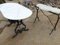 TWO CAST IRON TABLE BASES WITH ASSOCIATED MARBLE TOPS