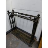 AN ANTIQUE COALBROOKDALE STYLE CAST IRON STICK STAND, THE TOP WITH SIX CIRCULAR HOLDERS, THE CENTRAL