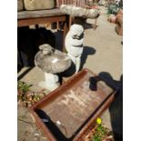 TWO COMPOSITE STONE BIRD BATHS ONE WITH PUTTO BASE THE OTHER A DOLPHIN TOGETHER WITH A STONEWARE