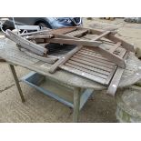 A TEAK GARDEN TABLE WITH THREE FOLDING CHAIRS.