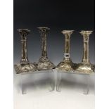 TWO PAIRS OF SILVER CANDLESTICKS BY THOMAS BRADBURY, LONDON 1898 AND 1918, THE GUN BARREL COLUMNS