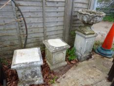 A PAIR OF COMPOSITE GARDEN PLINTHS TOGETHER WITH A SIMILAR URN ON STAND