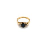 AN 18ct GOLD HALLMARKED SAPPHIRE AND DIAMOND THREE STONE RING. FINGER SIZE P. WEIGHT 3.09grms.