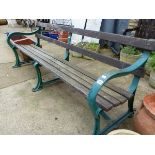 A LARGE ANTIQUE GARDEN BENCH WITH PAINTED CAST IRON SUPPORTS. H 74 x W 201 x D 73cms