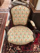 A PAIR OF FRENCH LOUIS XV STYLE CARVED ARMCHAIRS WITH FLORAL UPHOLSTERY