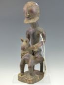 AN EARLY 20th C. DOGON MAHOGANY FIGURE OF A BEARDED NAKED MAN RIDING A HORSE. H 31cms.