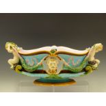 A MINTON MAJOLICA BOWL, DATE CODE FOR 1873, THE HANDLES MODELLED AS PUTTI HOLDING ENDS OF OAK