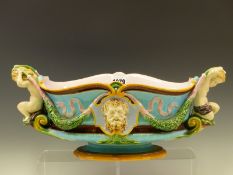 A MINTON MAJOLICA BOWL, DATE CODE FOR 1873, THE HANDLES MODELLED AS PUTTI HOLDING ENDS OF OAK