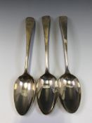 A PAIR OF GEORGE III SILVER OLD ENGLISH PATTERN SERVING SPOONS, LONDON 1805 TOGETHER WITH ANOTHER BY