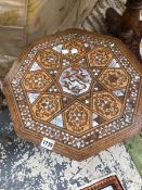 AN ISLAMIC OCTAGONAL TABLE, THE TOP GEOMETRICALLY INLAID IN MOTHER OF PEARL AND TWO TONES OF WOOD