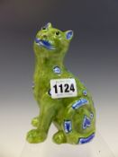 A MOSANIC POTTERY CAT, SEATED GLAZED IN GREEN AND DECORATED IN BLUE AND WHITE WITH HEARTS AND