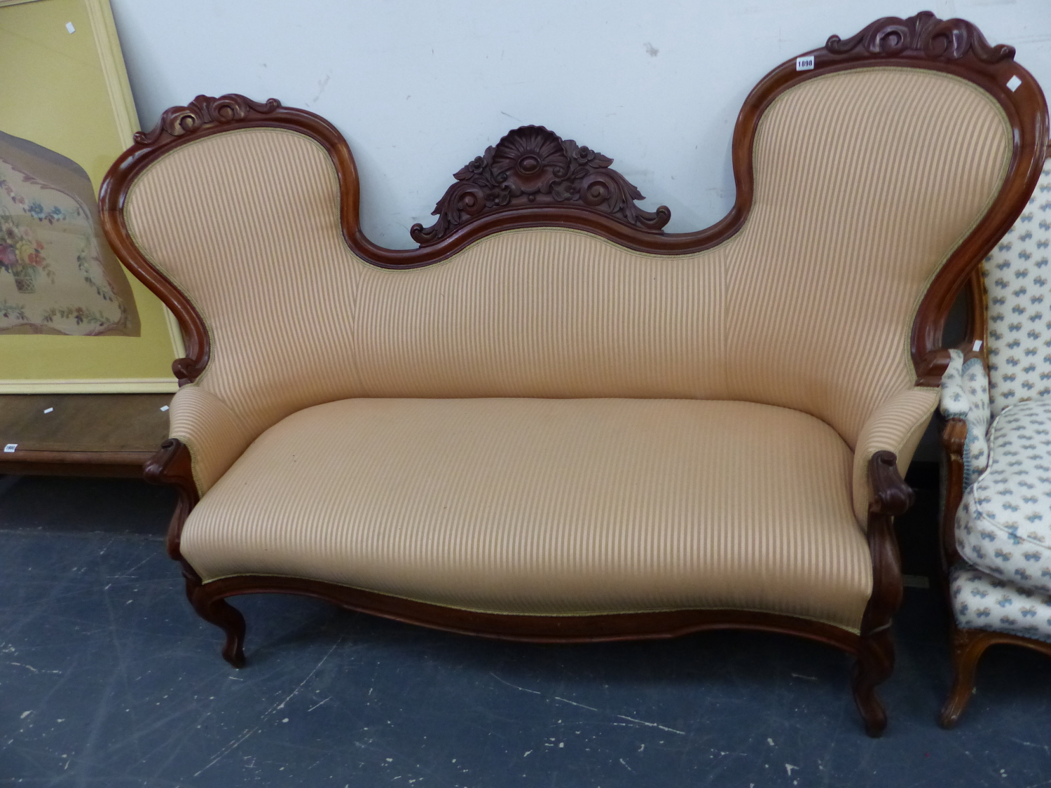 A VICTORIAN MAHOGANY SHOW FRAME SETTEE, THE CENTRAL SHELL AND FLOWER CARVING FLANKED BY HOOP