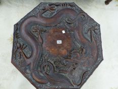 A 19th C. CHINESE PROVINCIAL HARDWOOD OCTAGONAL TABLE, THE TOP CARVED IN RELIEF WITH A DRAGON
