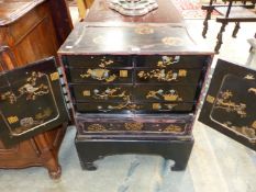 A LATE 19th C. JAPANESE BLACK LACQUER CABINET ON STAND GILT WITH ROUNDELS AND DECORATION, THE TWO