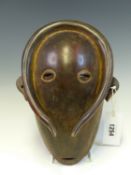 A MAHOGANY MASK, LATE 19th C. ZAIRE, THE POLISHED OVAL FACE PIERCED WITH EYES AND MOUTH, A