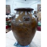 A MARTABAN HONEY BROWN GLAZED STORAGE JAR WITH WOOD STAND, THE OVOID BODY WITH FIVE LIONS HEADS