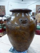 A MARTABAN HONEY BROWN GLAZED STORAGE JAR WITH WOOD STAND, THE OVOID BODY WITH FIVE LIONS HEADS