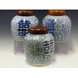 THREE SIMILAR CHINESE GINGER JARS WITH WOOD COVERS, EACH DECORATED WITH SHOU CHARACTERS ON GROUNDS