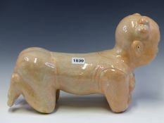 A CHINESE PILLOW MODELLED A CHILDS BACK AS IT RESTS ON ITS KNEES AND ELBOWS, THE GLAZE PINK