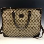 A MEDIUM GUCCI BROWN CANVAS TOTE BAG COMPLETE WITH SHOULDER STRAP. W 39 x H 31cms.