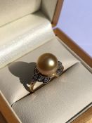 A HALLMARKED 9ct GOLD GOLDEN SOUTH SEA PEARL AND WHITE ZIRCON DRESS RING. PEARL APPROX 9mm. FINGER