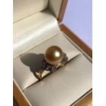 A HALLMARKED 9ct GOLD GOLDEN SOUTH SEA PEARL AND WHITE ZIRCON DRESS RING. PEARL APPROX 9mm. FINGER