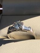 A PLATINUM AND DIAMOND TRILOGY RING. THE CENTRAL DIAMOND APPROX. ESTIMATED WEIGHT 0.70cts, I/SI2/3