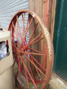 TWO LARGE PAINTED CAST IRON WAGON WHEELS.